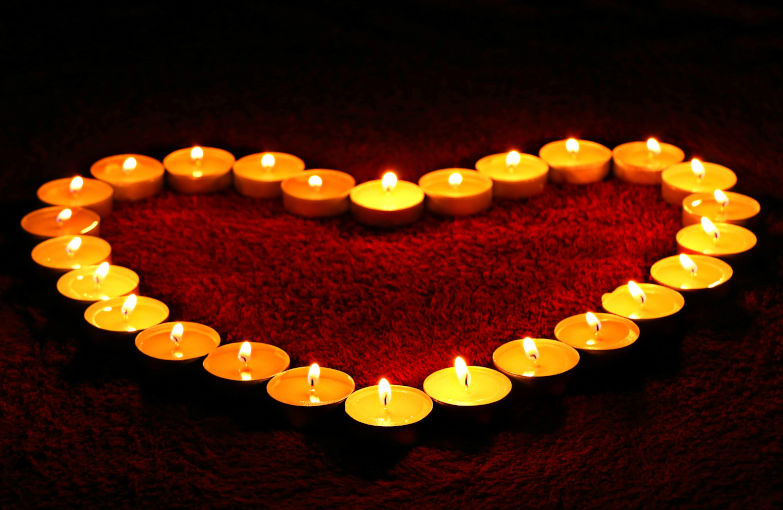 A set of candles arranged in the shape of a heart.